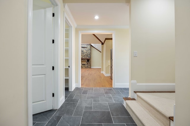 hall featuring crown molding and dark wood-type flooring