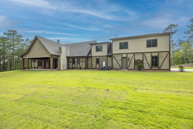 rear view of property with a yard