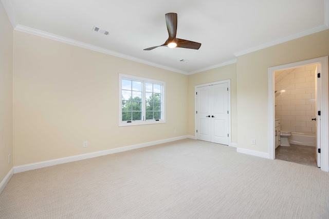 unfurnished bedroom featuring ensuite bathroom, ceiling fan, ornamental molding, light colored carpet, and a closet