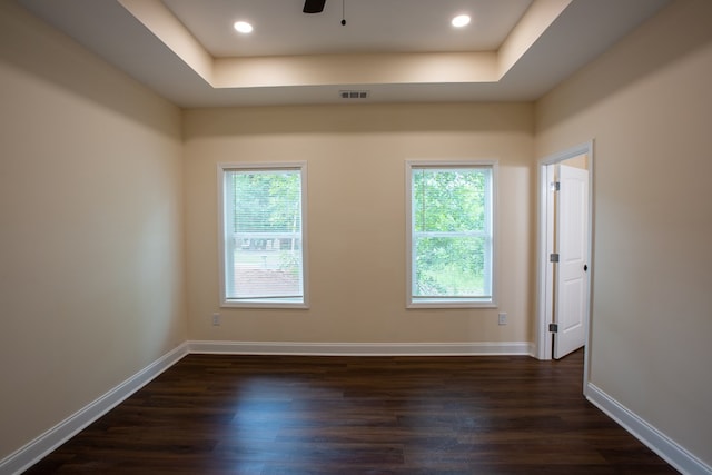 923 Omega Dr, Columbus, GA 31907 - empty room with dark wood-style flooring, a tray ceiling, and a ceiling fan
