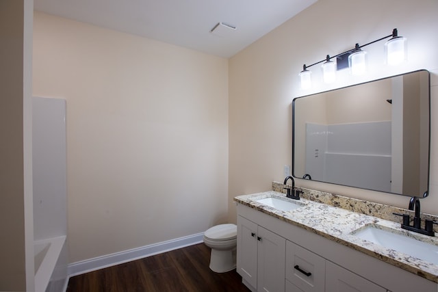 923 Omega Dr, Columbus, GA 31907 - full bathroom with double vanity, wood finished floors, and a bathtub