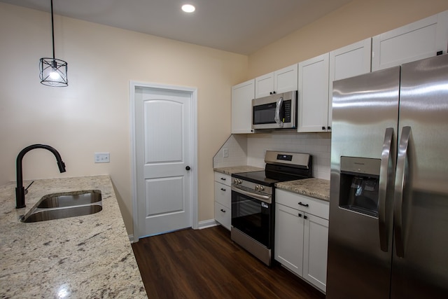 923 Omega Dr, Columbus, GA 31907 - kitchen featuring appliances with stainless steel finishes, dark wood-style floors, tasteful backsplash, light stone countertops, and white cabinets