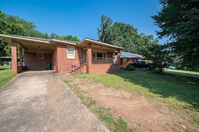4721 Drew Ave, Columbus, GA 31904 - view of front facade featuring asphalt driveway, brick siding, a front yard, an attached carport, and covered porch