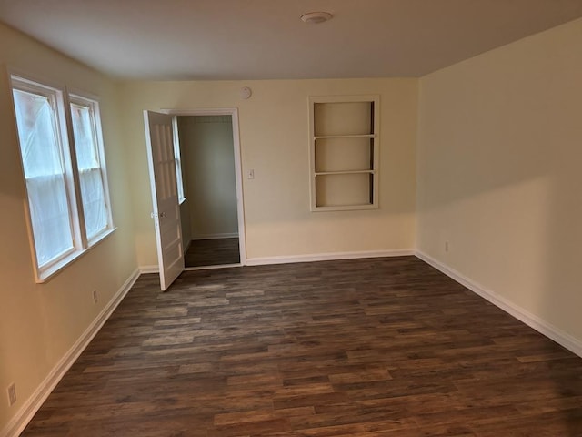 unfurnished bedroom with dark hardwood / wood-style flooring