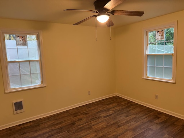 unfurnished room with dark hardwood / wood-style floors and ceiling fan