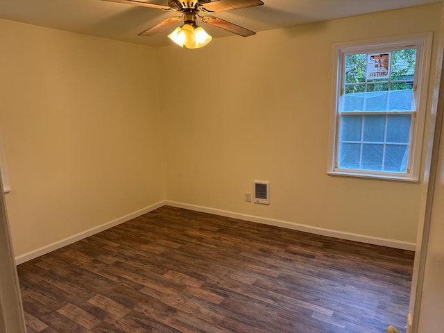 empty room featuring ceiling fan and dark wood-type flooring