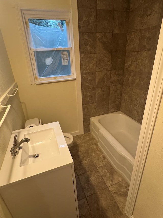 bathroom with tile patterned flooring, vanity, and toilet