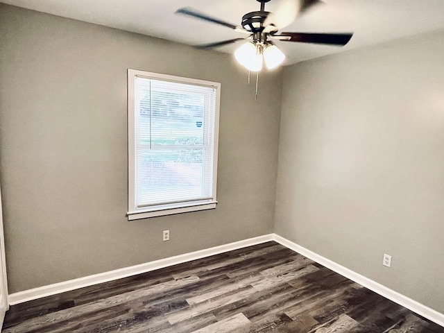 empty room with ceiling fan and dark wood-type flooring