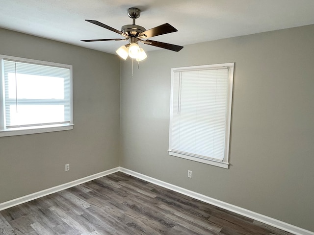 empty room featuring dark hardwood / wood-style flooring and ceiling fan