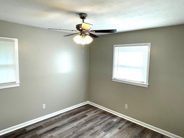 spare room with ceiling fan and dark hardwood / wood-style floors