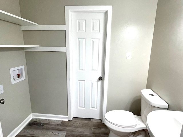 bathroom featuring toilet and wood-type flooring