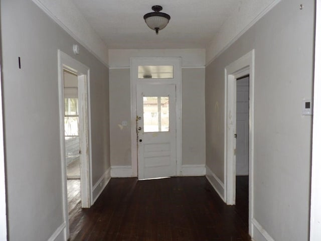 entrance foyer with dark wood-style floors and baseboards