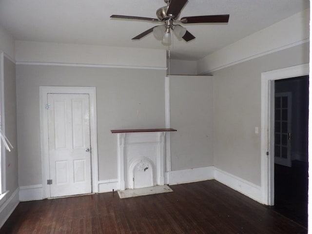 interior space featuring a ceiling fan, a fireplace, baseboards, and dark wood-style flooring