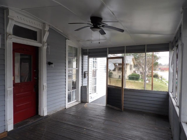 unfurnished sunroom with a ceiling fan