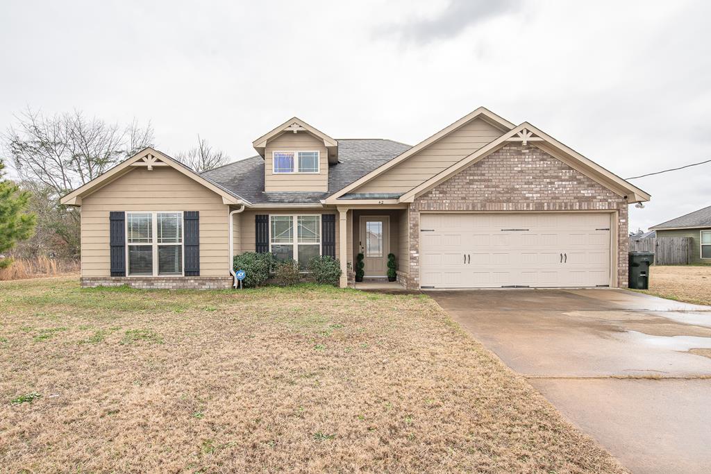 craftsman-style home with a garage and a front lawn