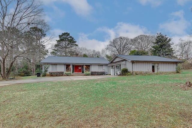 ranch-style home with a garage and a front lawn