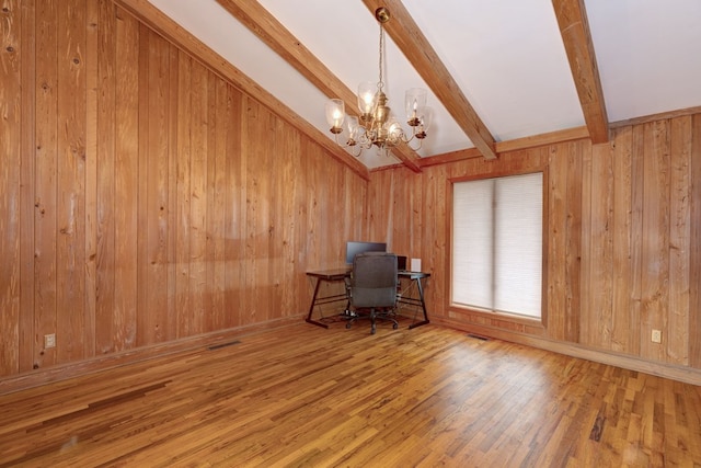 unfurnished office with a notable chandelier, beam ceiling, wood-type flooring, and wood walls