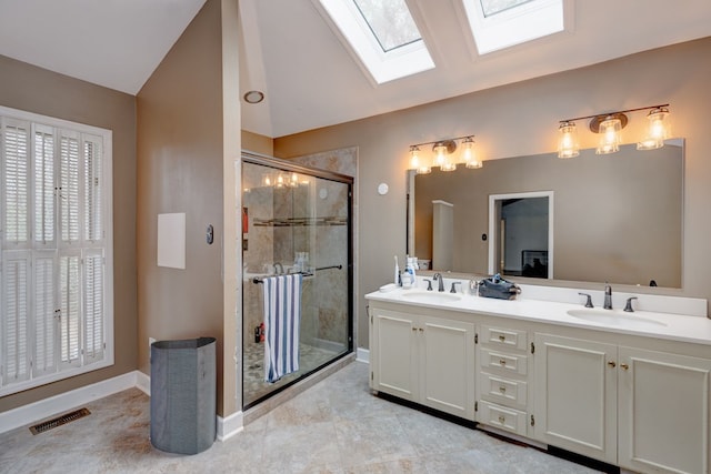 bathroom with walk in shower, vanity, and lofted ceiling with skylight