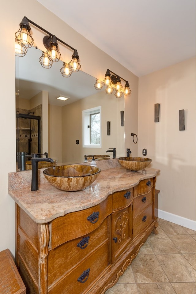 bathroom featuring vanity, a shower with shower door, and tile patterned flooring