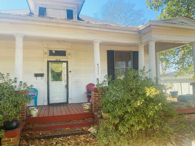 view of exterior entry with a porch