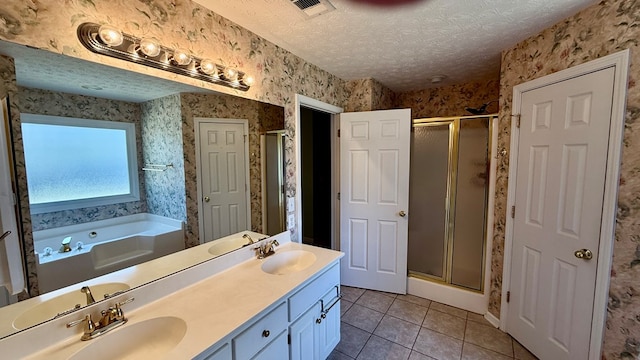 bathroom featuring tile patterned floors, plus walk in shower, a textured ceiling, and vanity