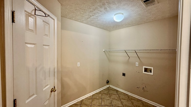 laundry area with washer hookup, tile patterned floors, hookup for an electric dryer, and a textured ceiling