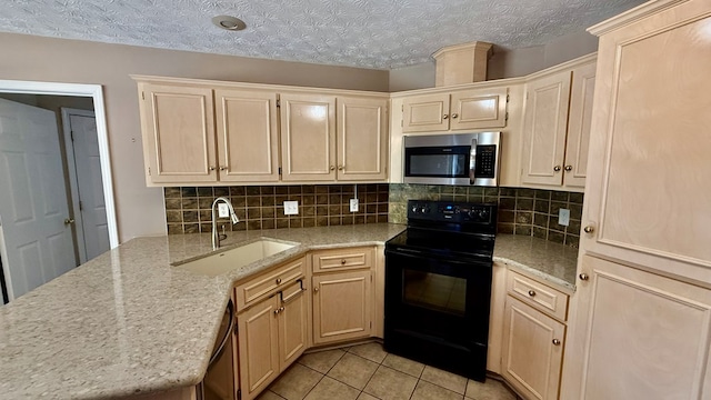 kitchen with light tile patterned flooring, sink, light stone counters, tasteful backsplash, and black appliances