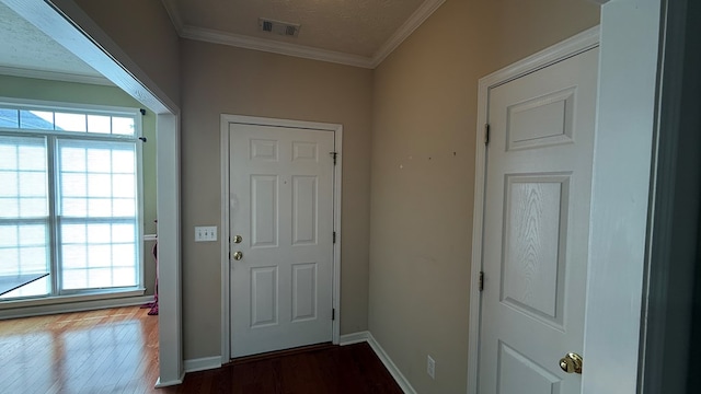 doorway to outside featuring wood-type flooring, ornamental molding, and a textured ceiling