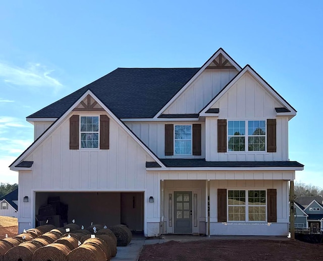 view of front of property with a porch, board and batten siding, an attached garage, and a shingled roof