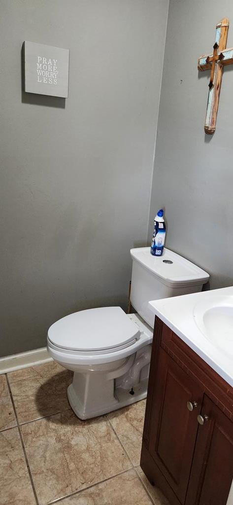 bathroom with tile patterned floors, vanity, and toilet