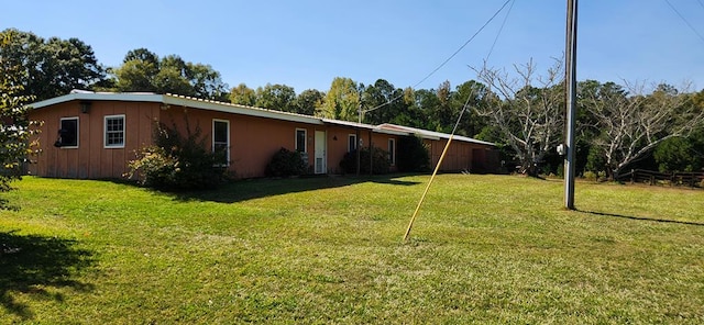 view of side of property with a lawn