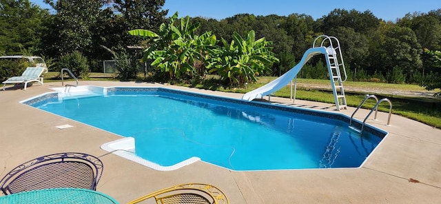 view of swimming pool featuring a patio area and a water slide