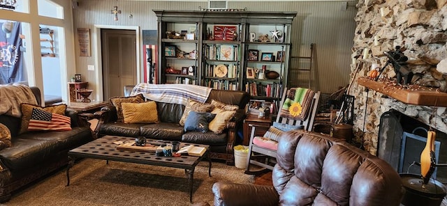 sitting room featuring a fireplace and carpet