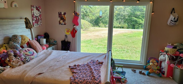 carpeted bedroom featuring multiple windows