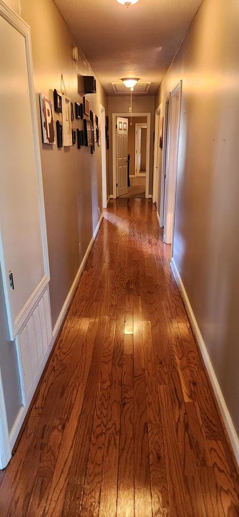 corridor featuring wood-type flooring