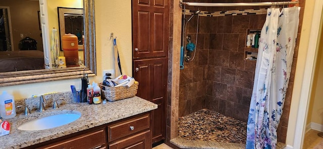 bathroom featuring vanity and curtained shower