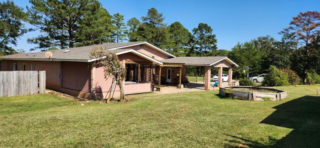 back of property featuring a yard and a patio