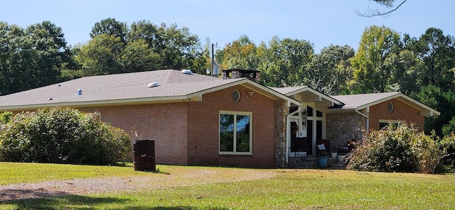 rear view of property with a lawn