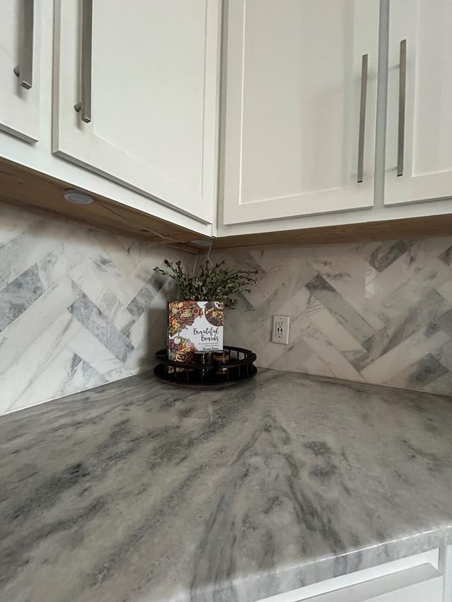 interior details with light stone counters and white cabinets