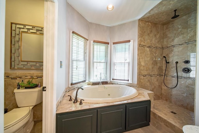 bathroom featuring plus walk in shower, toilet, and a wealth of natural light