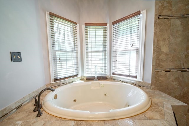 bathroom with tiled bath and plenty of natural light