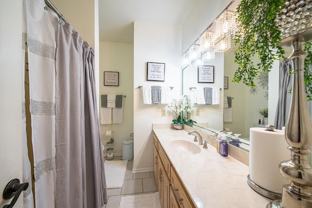 bathroom featuring tile patterned flooring, vanity, and a chandelier