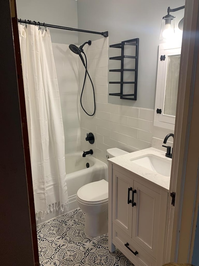 bathroom with toilet, a wainscoted wall, crown molding, vanity, and tile walls