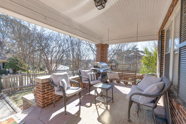 view of patio featuring fence and an outdoor hangout area