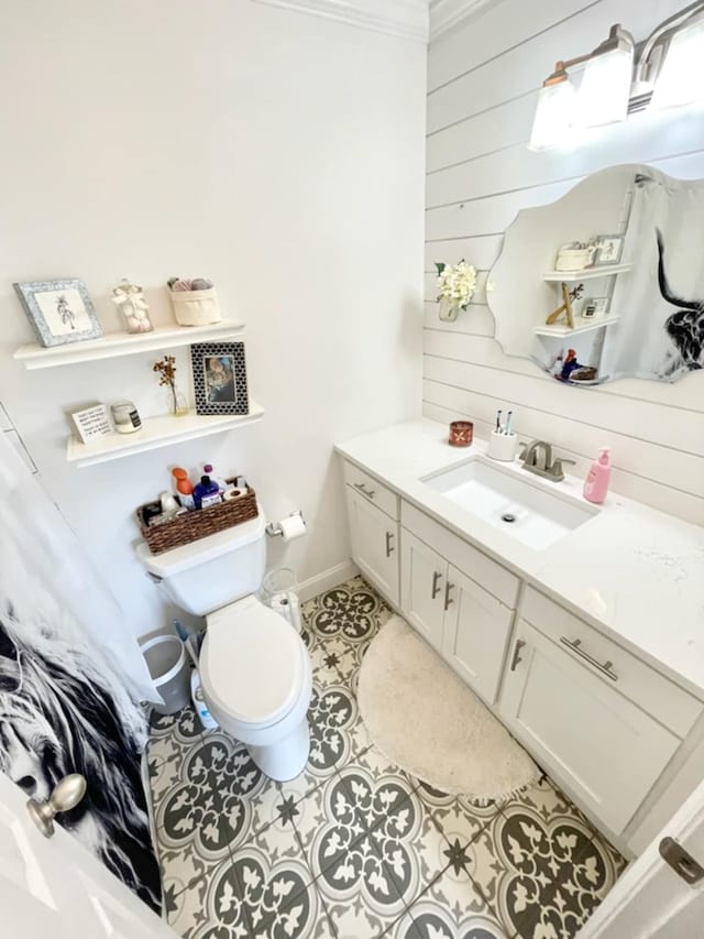4502 Northwood Ave, Columbus, GA 31907 - bathroom with wooden walls, vanity, toilet, tile patterned floors, and baseboards