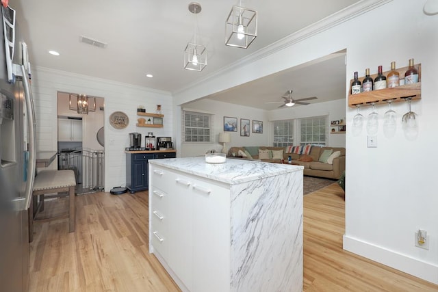 4502 Northwood Ave, Columbus, GA 31907 - kitchen featuring ornamental molding, light wood-style flooring, freestanding refrigerator, a kitchen island, and decorative light fixtures
