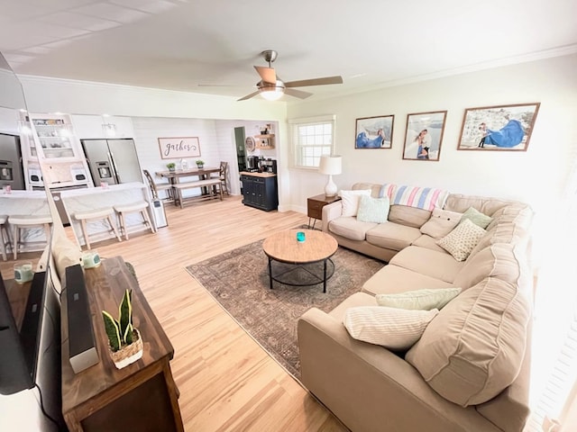 4502 Northwood Ave, Columbus, GA 31907 - living room featuring ornamental molding, light wood-style floors, a ceiling fan, and baseboards