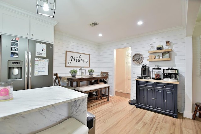 4502 Northwood Ave, Columbus, GA 31907 - kitchen featuring stainless steel fridge, ornamental molding, light countertops, light wood-style flooring, and open shelves