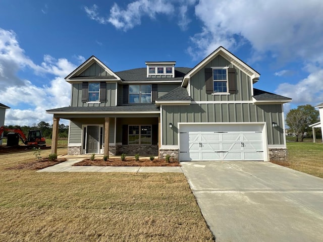 craftsman-style house with covered porch, a front yard, and a garage