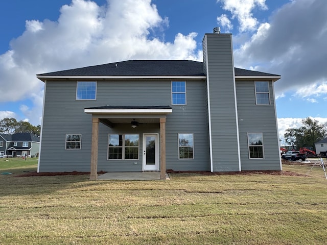 back of house with a yard, ceiling fan, and a patio area